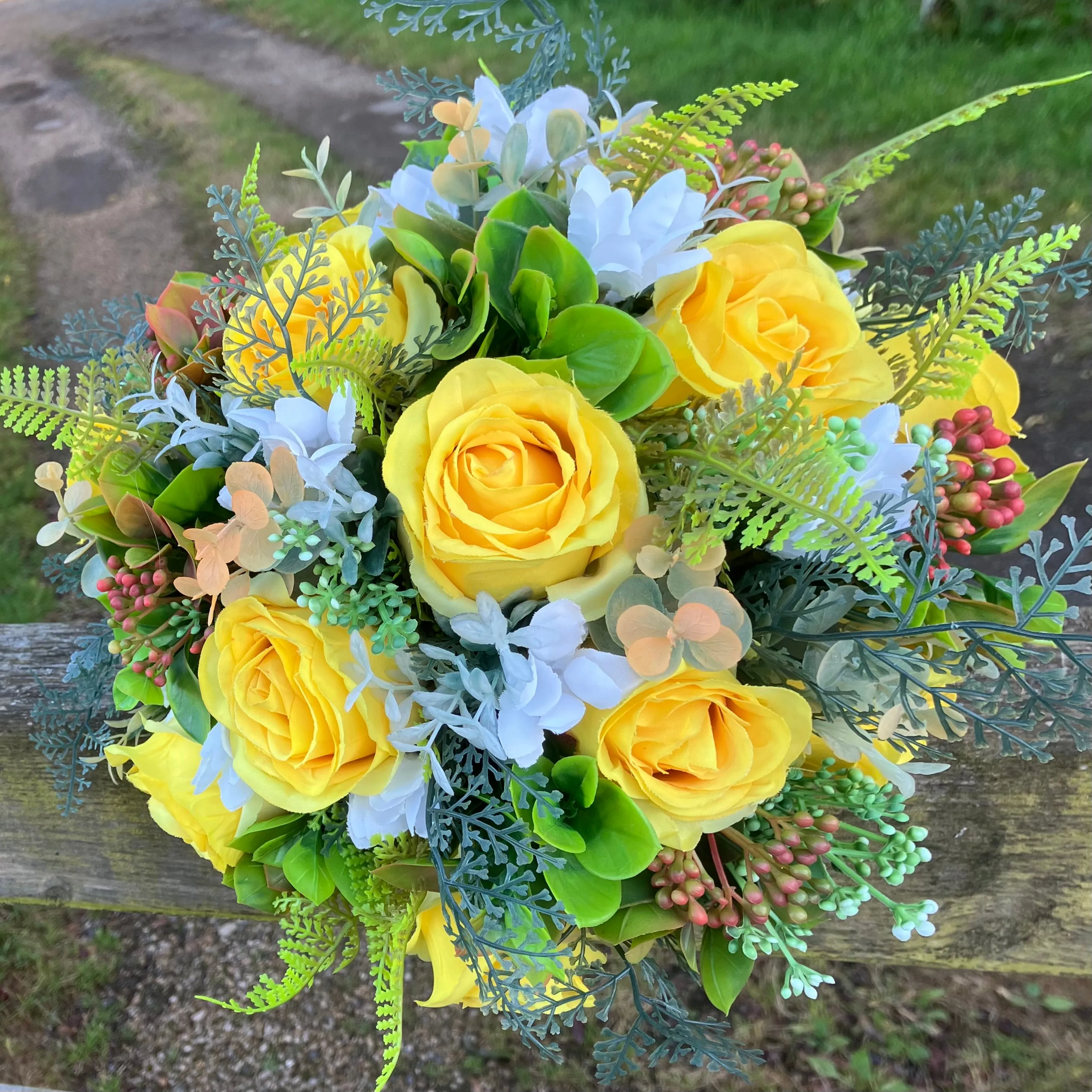 A brides bouquet of roses, peonies and fern