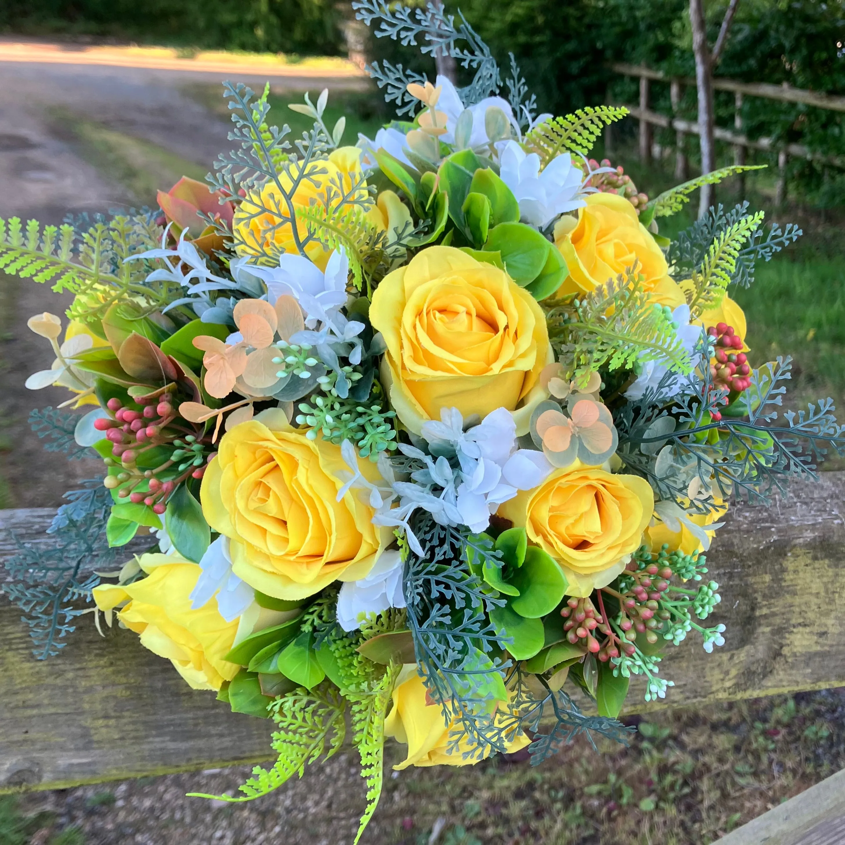 A brides bouquet of roses, peonies and fern