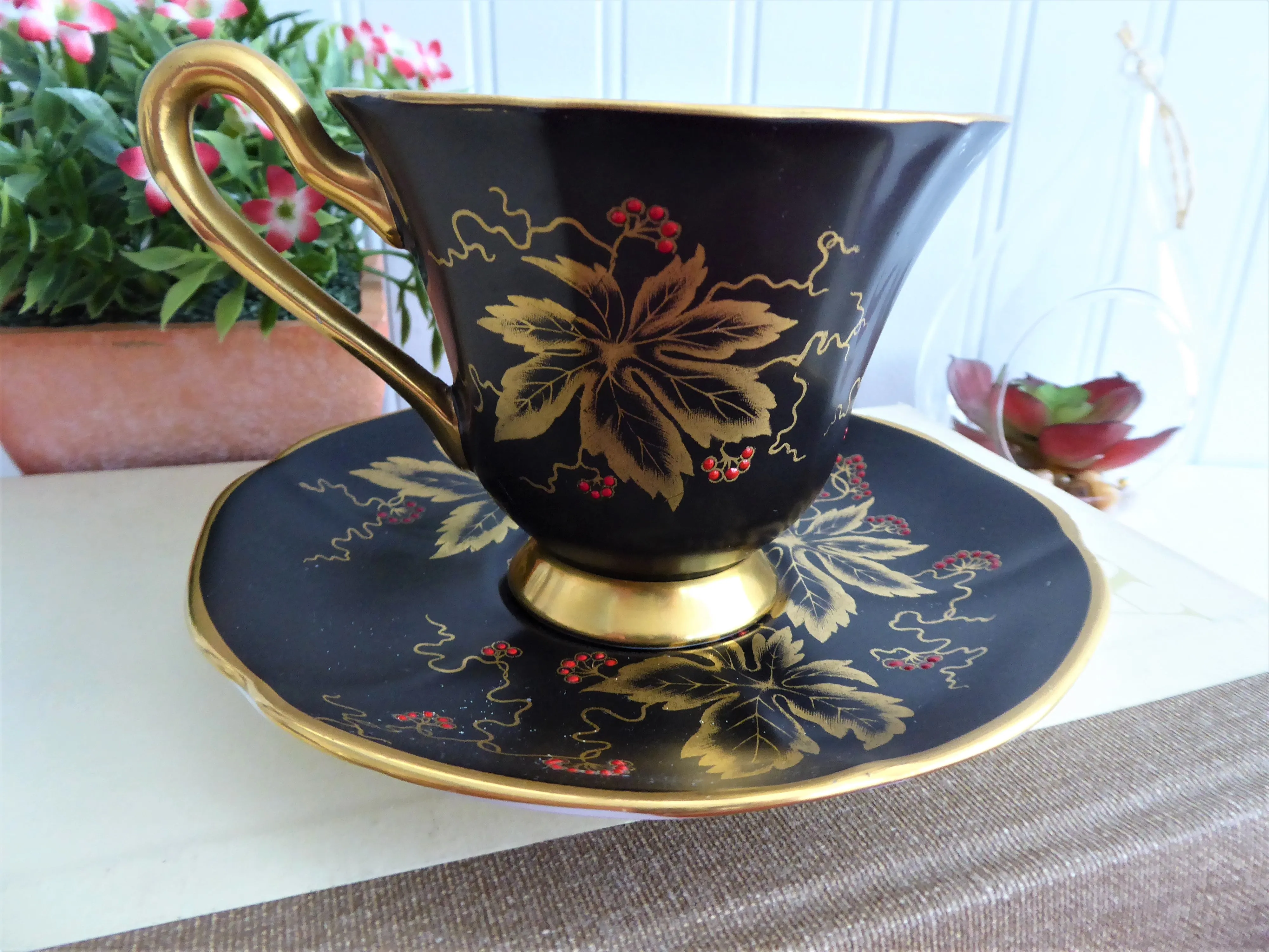 Elegant Black Cup And Saucer Metallic Gold Leaves Red Enamel Tuscan 1940s