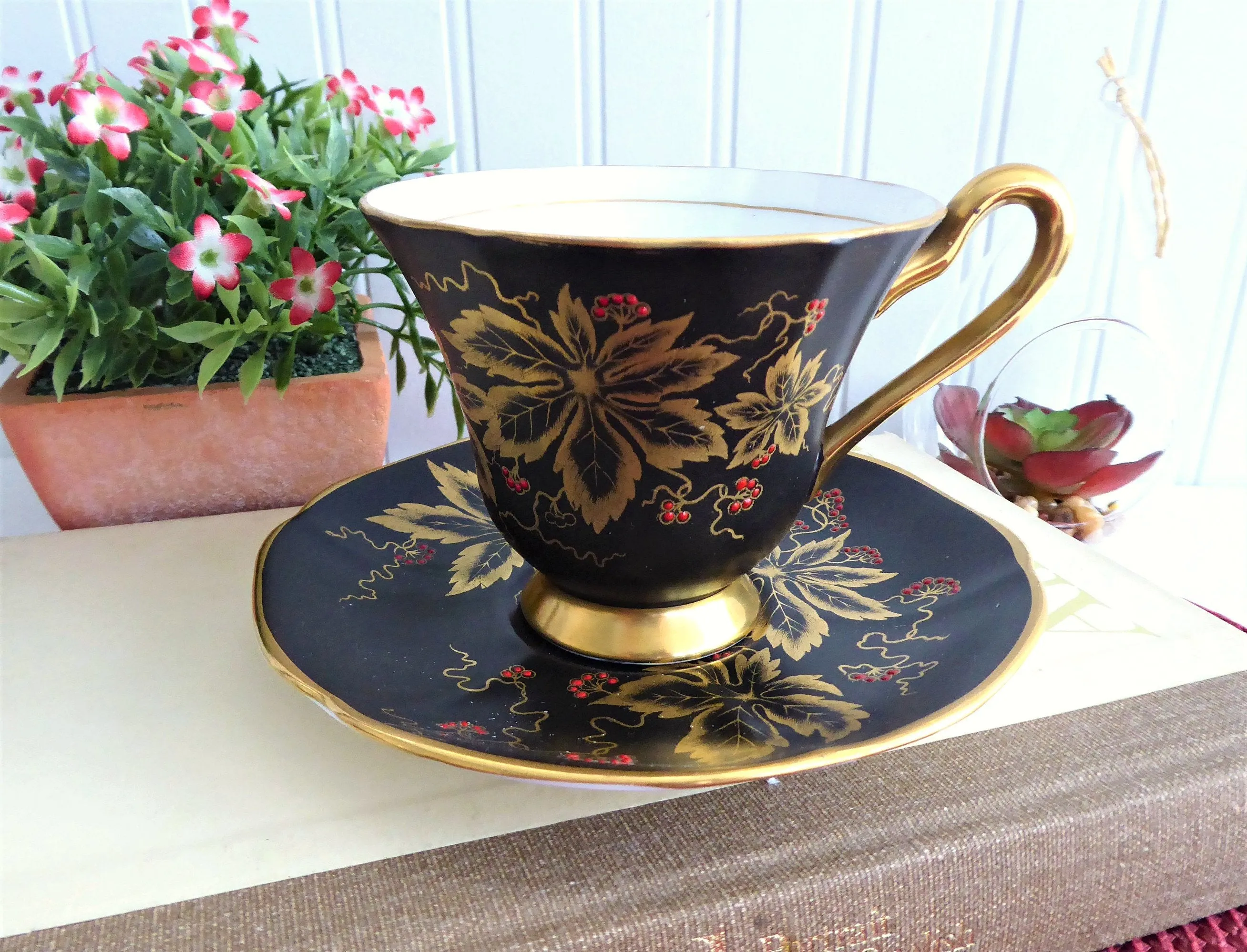 Elegant Black Cup And Saucer Metallic Gold Leaves Red Enamel Tuscan 1940s