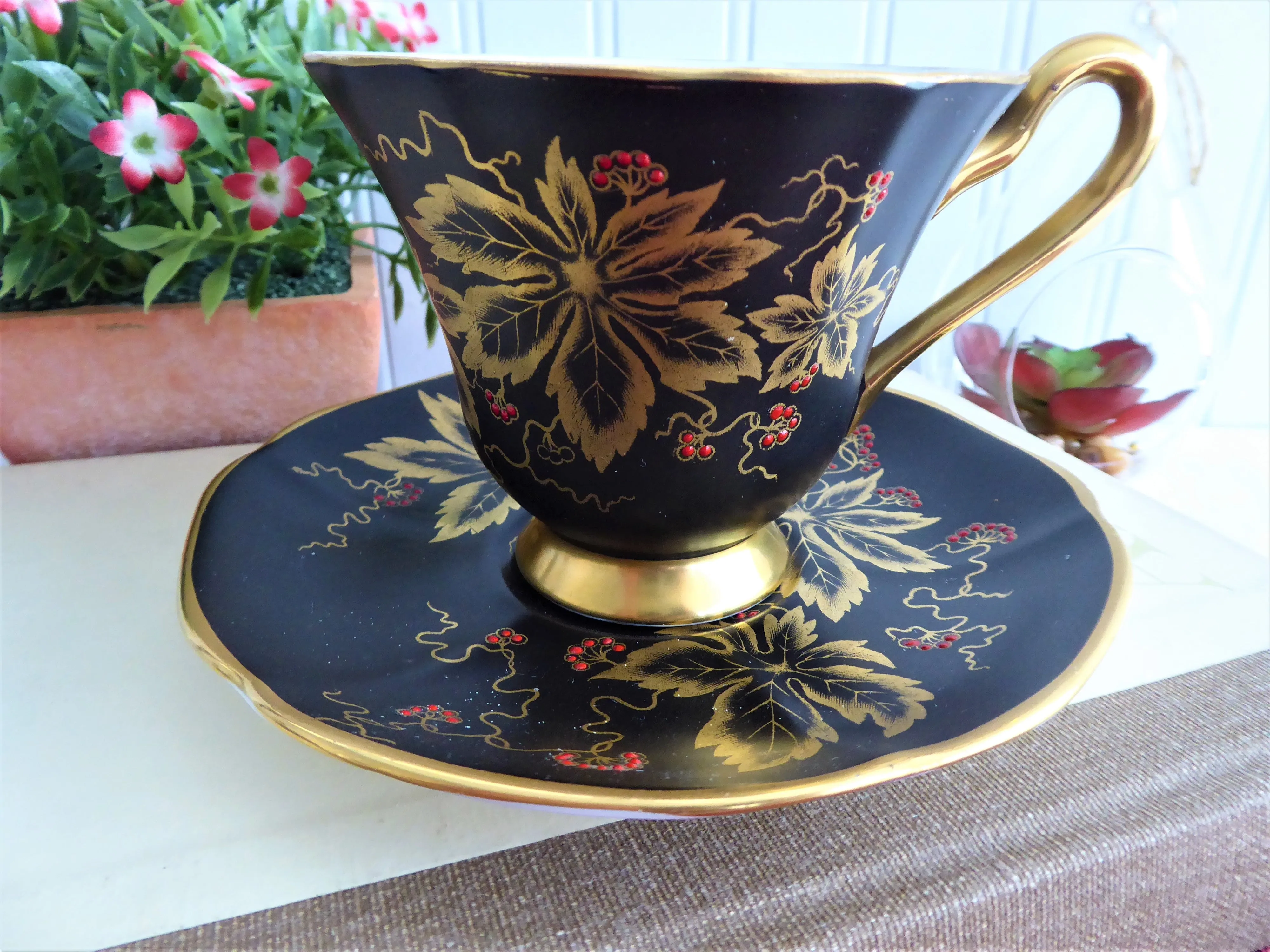 Elegant Black Cup And Saucer Metallic Gold Leaves Red Enamel Tuscan 1940s