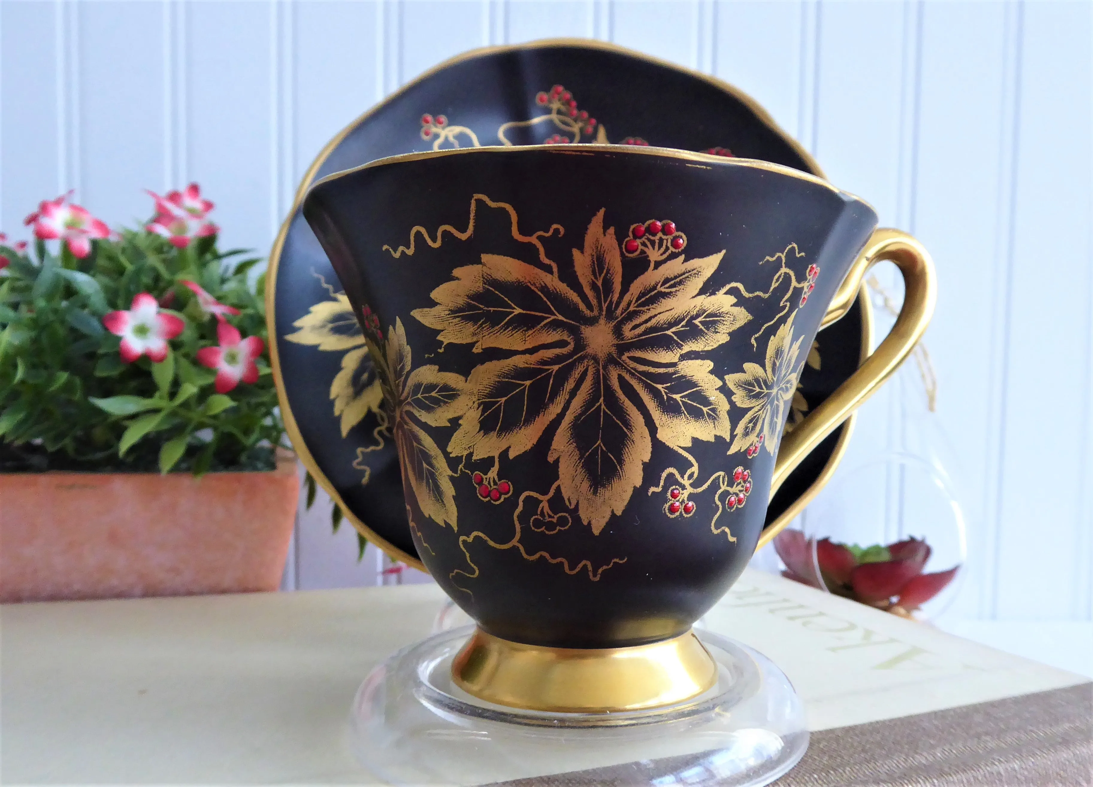 Elegant Black Cup And Saucer Metallic Gold Leaves Red Enamel Tuscan 1940s