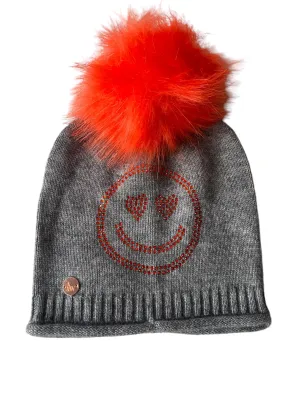 Grey cashmere plain knit beanie with an orange smiley embellishment & faux fur pom