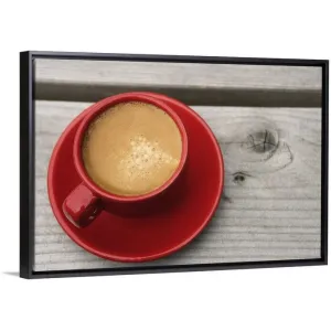 "A bright red cup of espresso coffee on a picnic table outdoors on a summer day." Black Float Frame Canvas Art