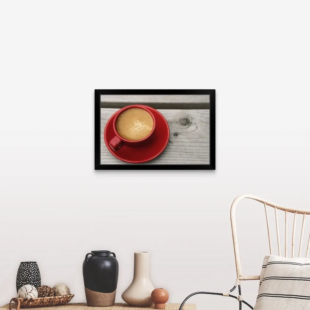 "A bright red cup of espresso coffee on a picnic table outdoors on a summer day." Black Framed Print