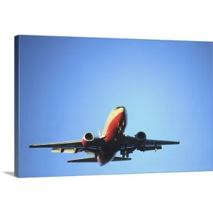 "Aeroplane flying across blue sky" Canvas Wall Art