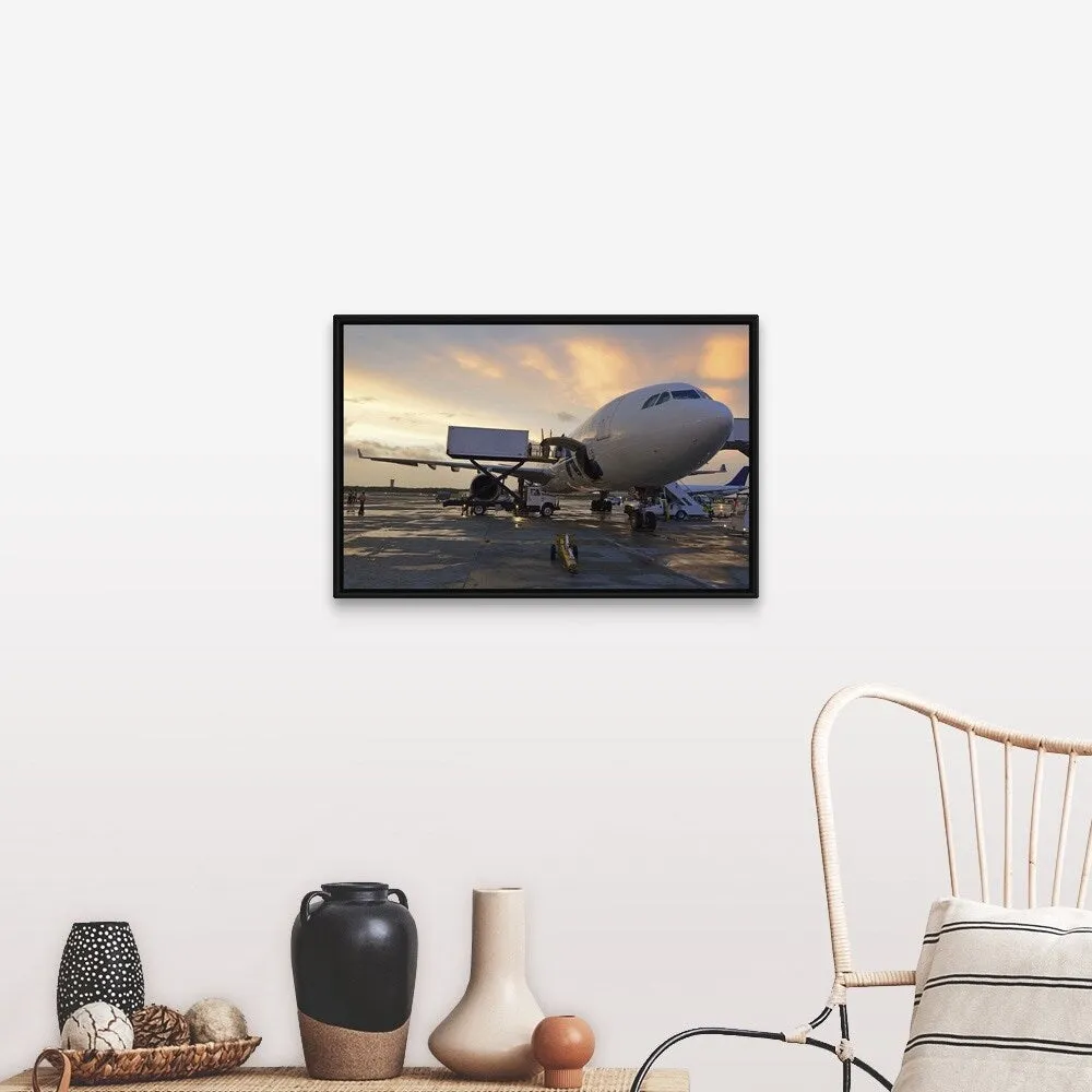 "Airplane on tarmac at sunset" Black Float Frame Canvas Art