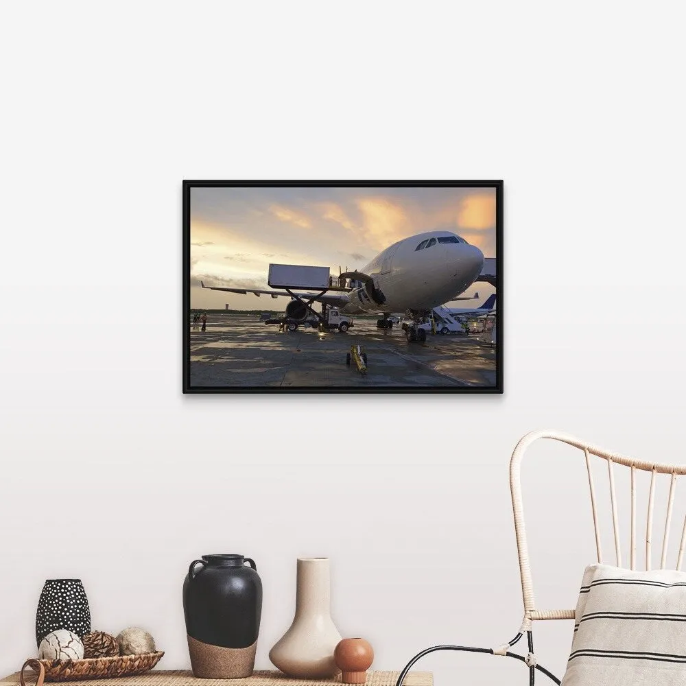 "Airplane on tarmac at sunset" Black Float Frame Canvas Art