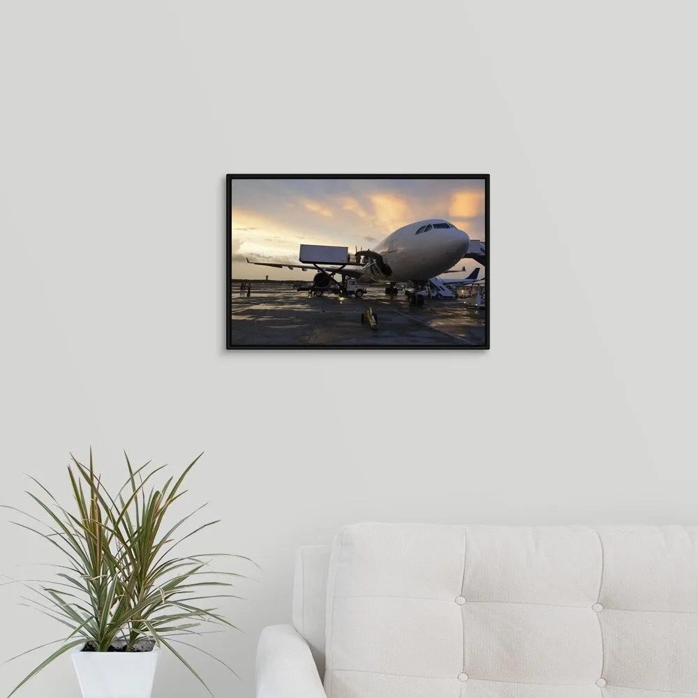 "Airplane on tarmac at sunset" Black Float Frame Canvas Art