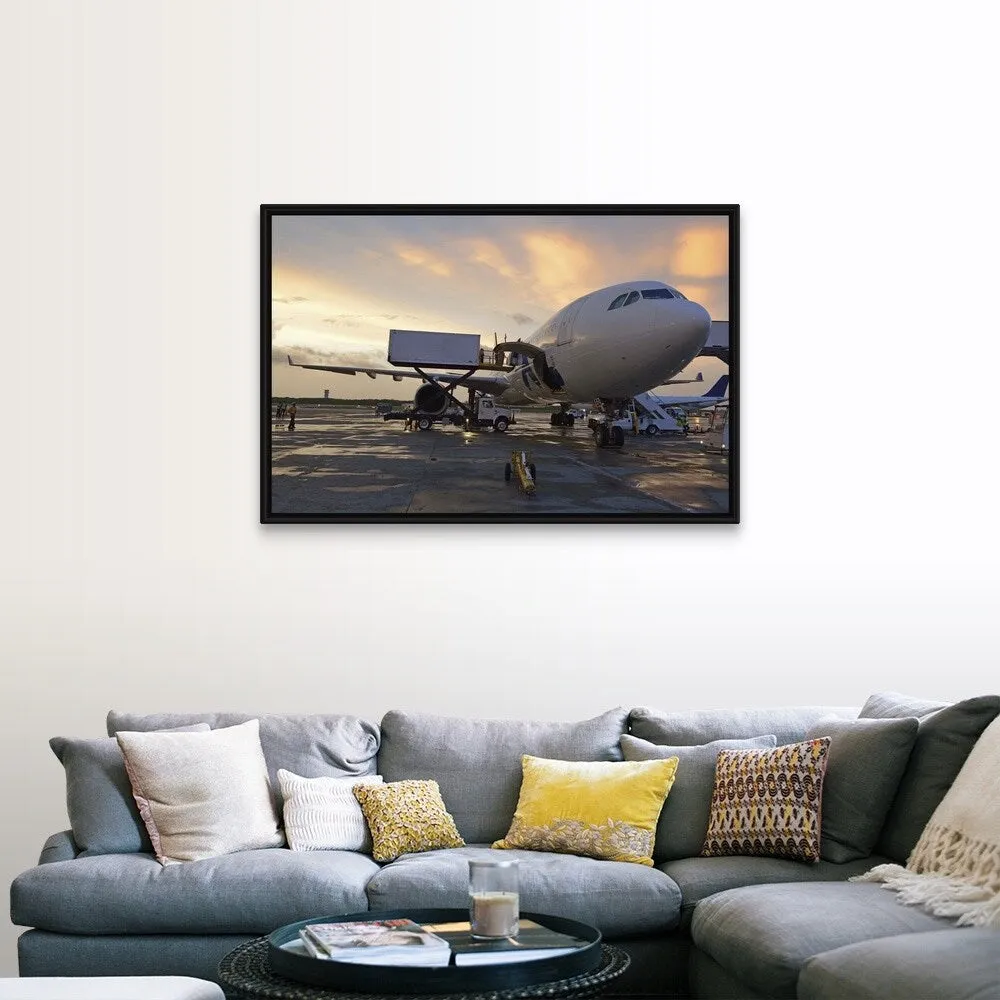 "Airplane on tarmac at sunset" Black Float Frame Canvas Art