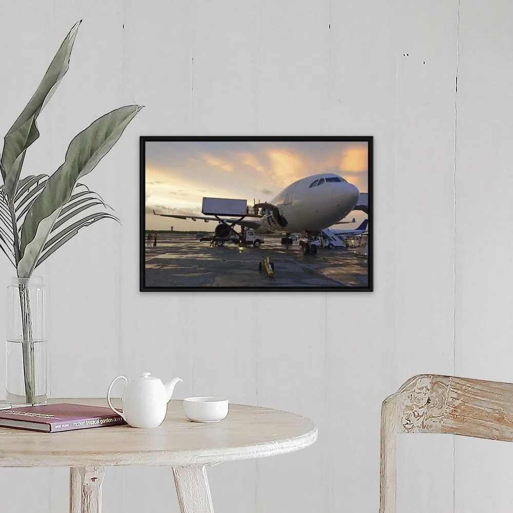 "Airplane on tarmac at sunset" Black Float Frame Canvas Art