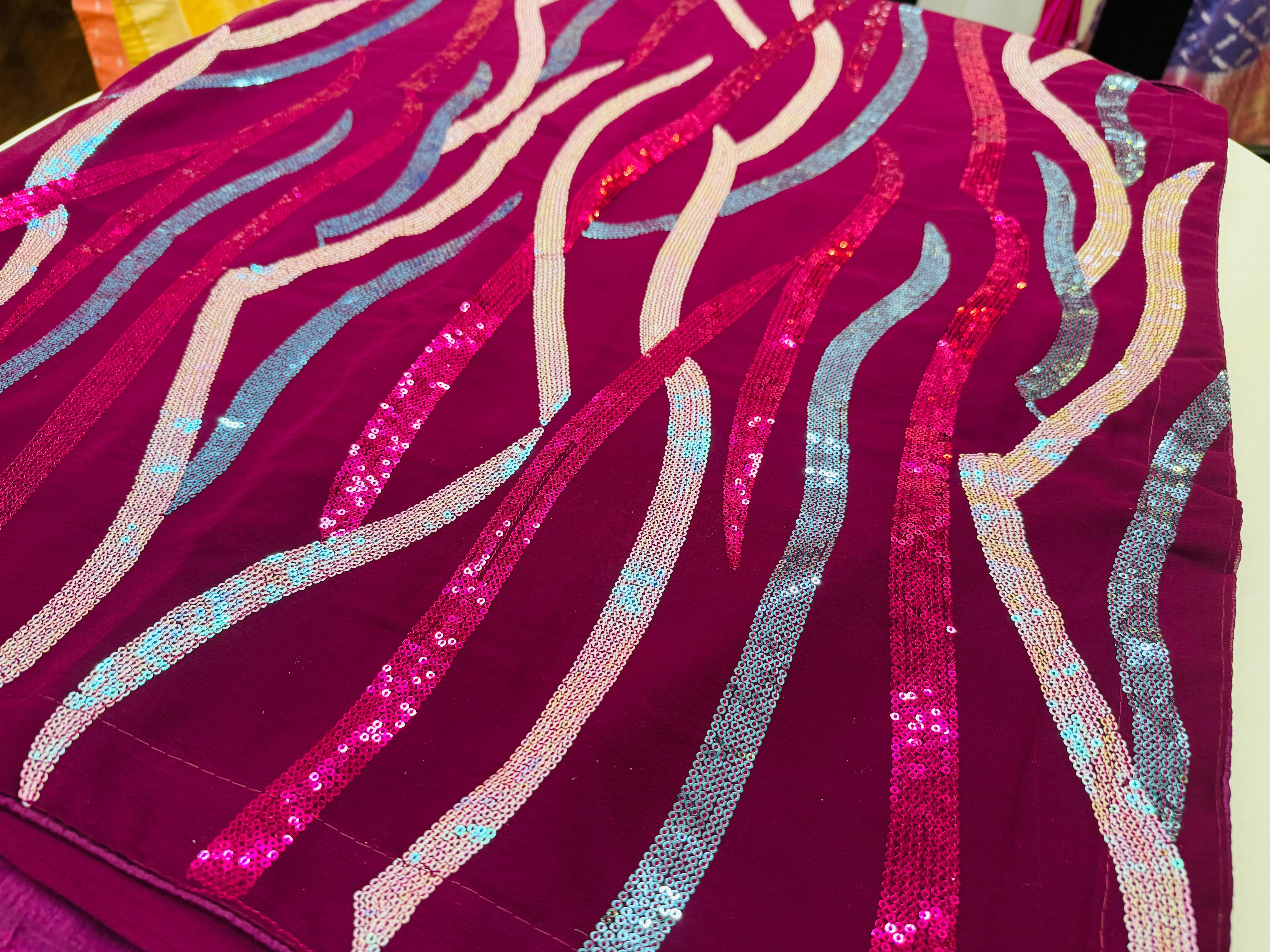 Vibrant Magenta Chiffon Saree with Multicolored Sequin Wave Patterns